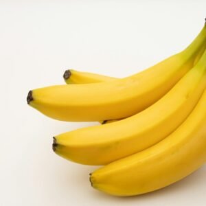 a bunch of bananas sitting on top of a white table