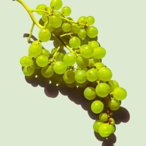 a bunch of green grapes sitting on top of a table